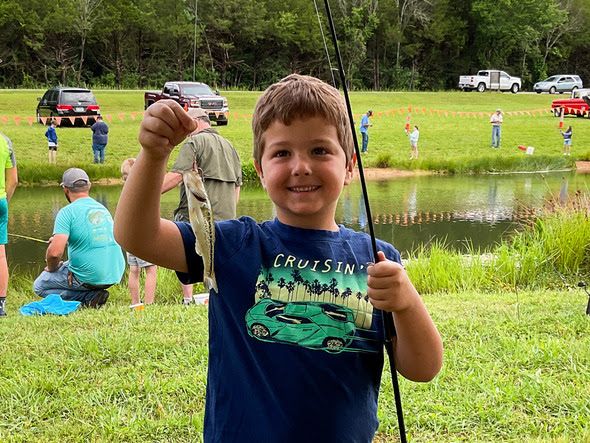 Child holds fish
