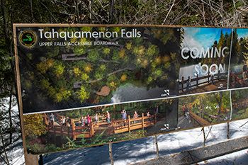 A construction sign advertising the new boardwalk project is shown.