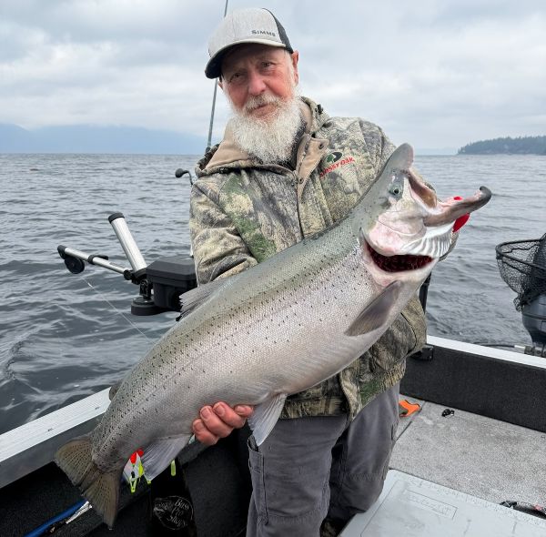 Angler on Lake Pend Oreille with a rainbow trout