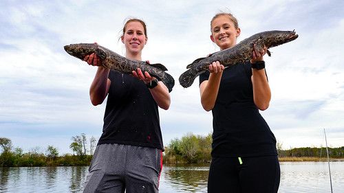 Two young women holding fish