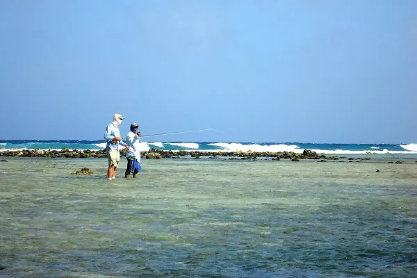 Fly anglers wade the flats at Turneffe Atoll, a premier bonefish, permit, and tarpon destination in Belize.