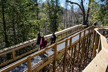 Park visitors enjoy the new boardwalk Thursday at the Upper Tahquamenon Falls.